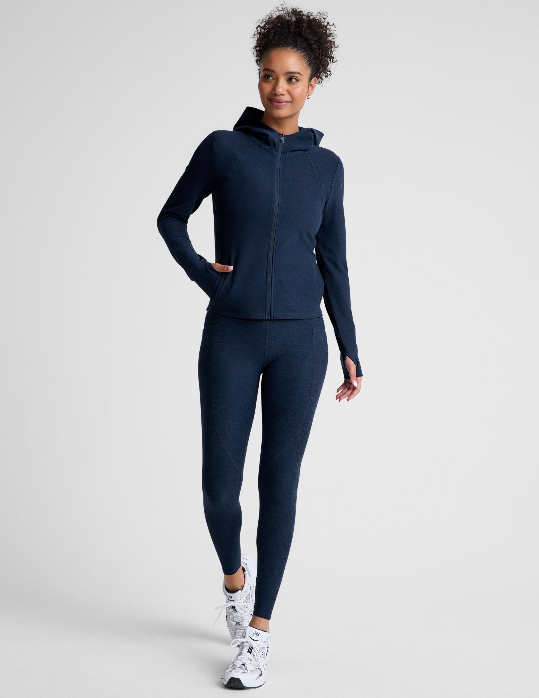 blue zip-up hooded jacket with thumbholes.