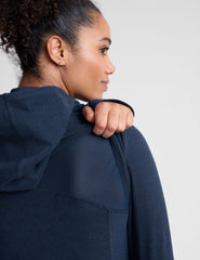 blue zip-up hooded jacket with thumbholes.