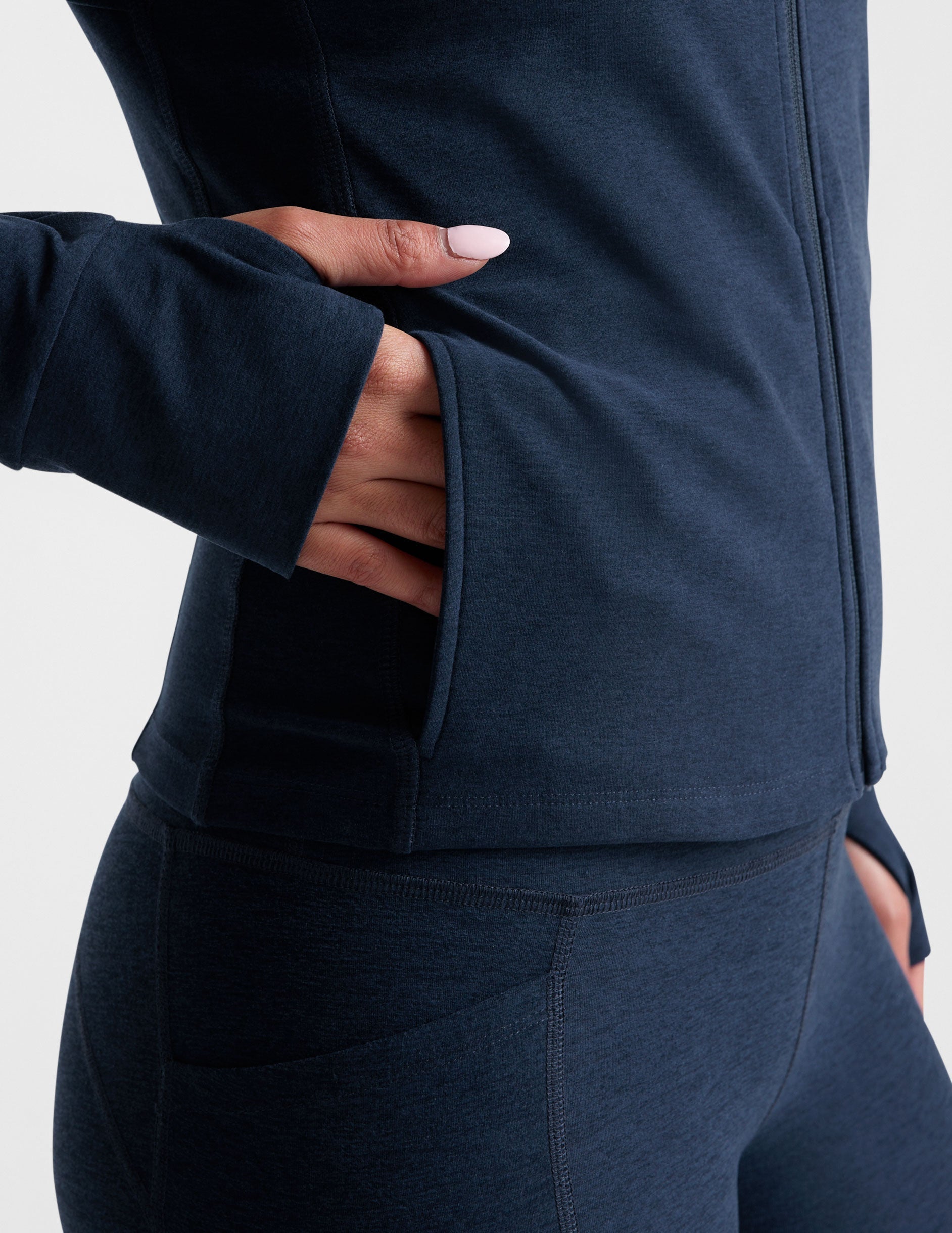 blue zip-up hooded jacket with thumbholes.