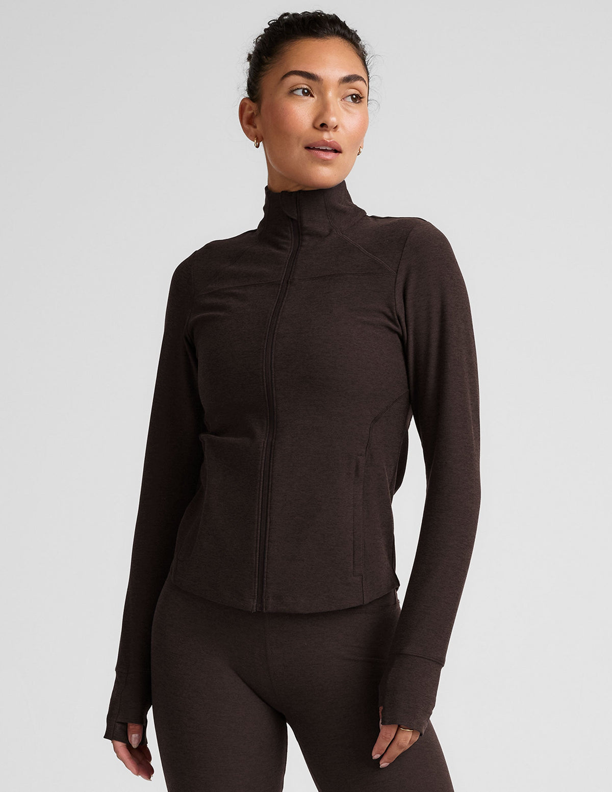 brown zip-up mock neck jacket with pockets and thumbholes.