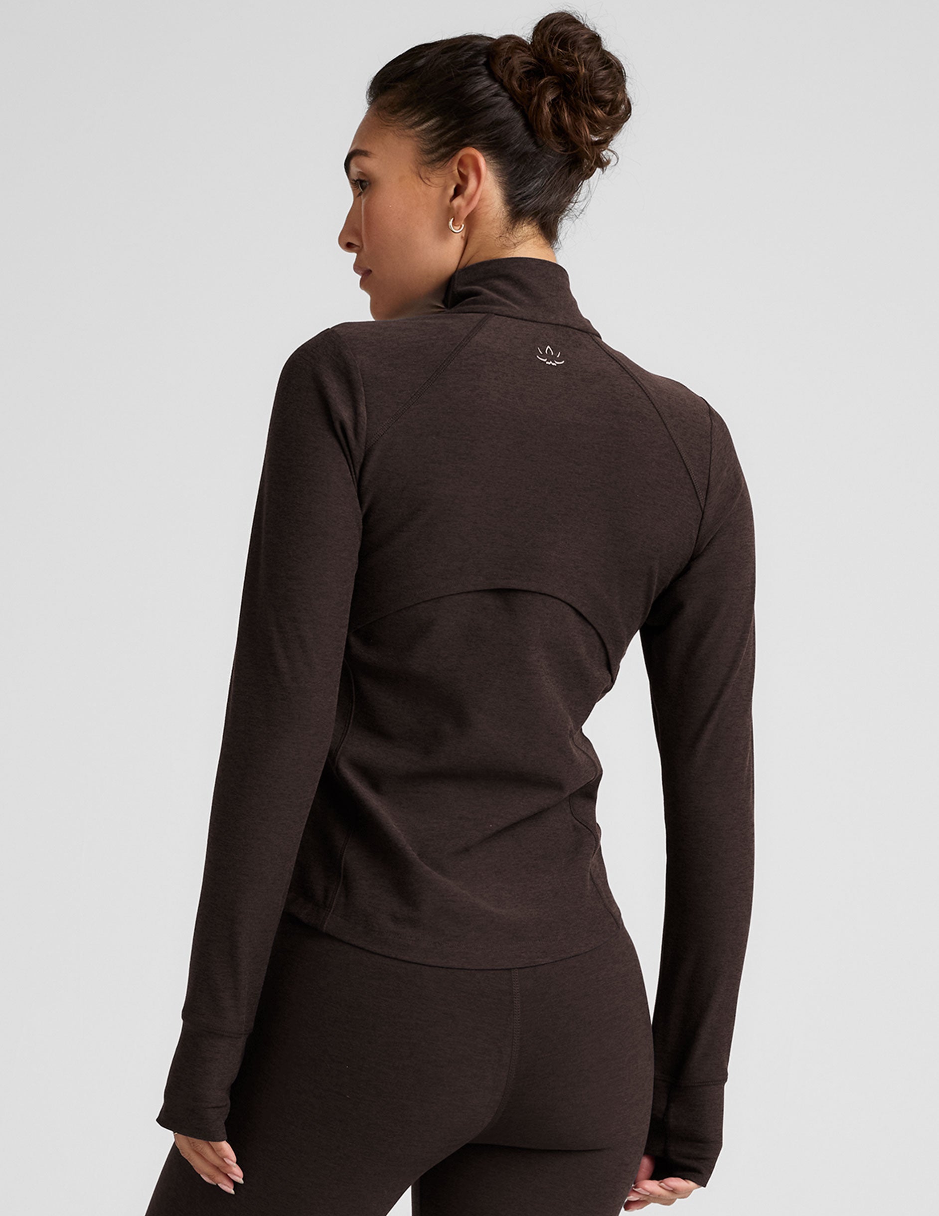 brown zip-up mock neck jacket with pockets and thumbholes.
