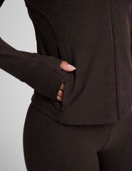 brown zip-up mock neck jacket with pockets and thumbholes.
