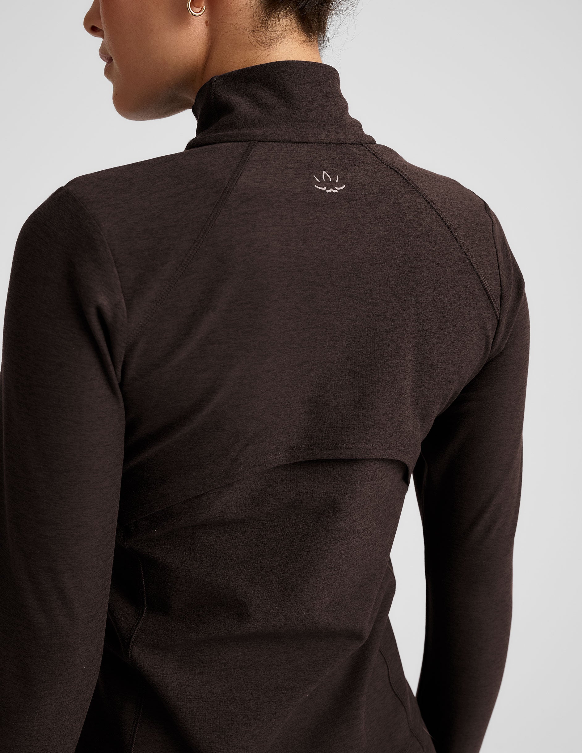 brown zip-up mock neck jacket with pockets and thumbholes.