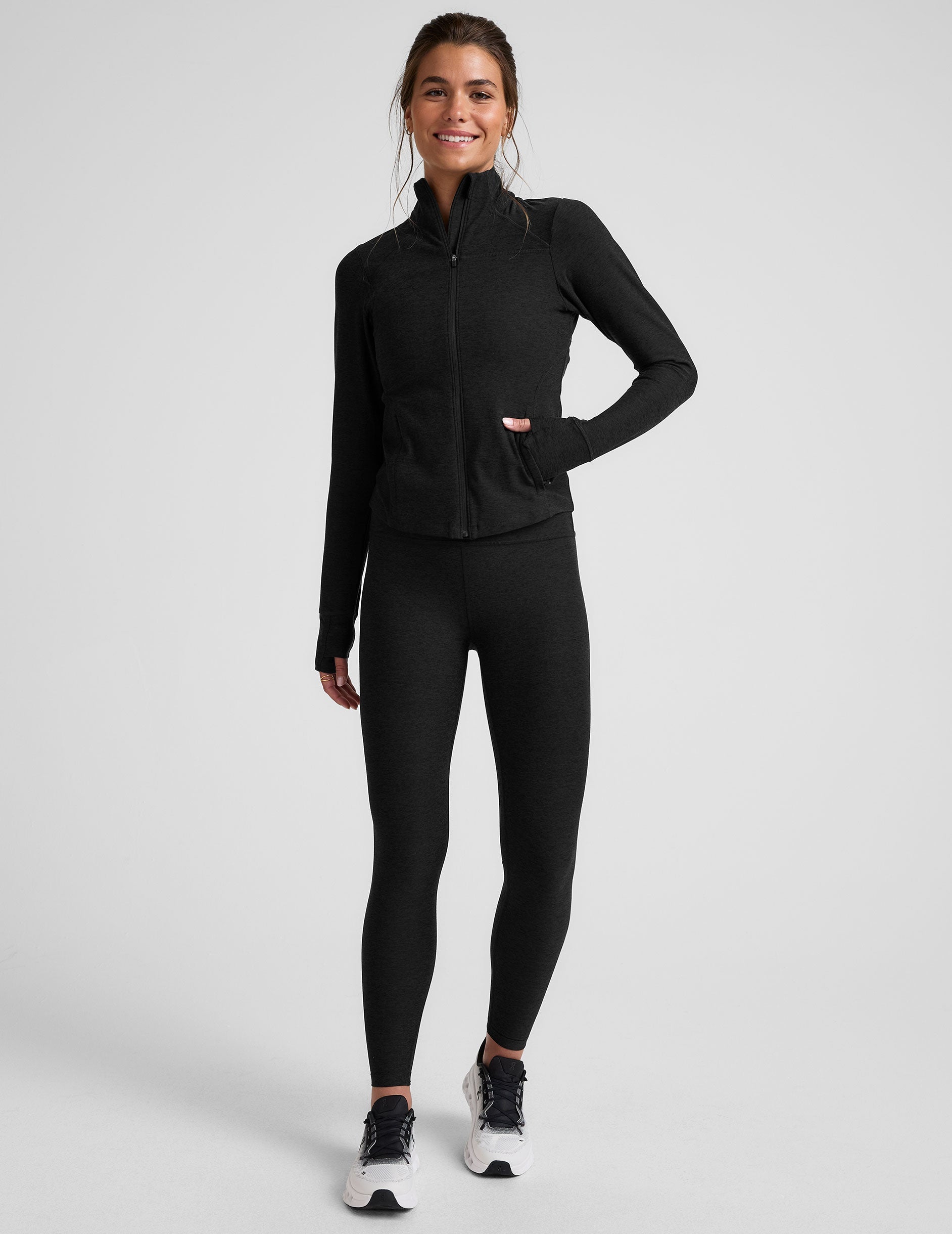 black zip-up mock neck jacket with pockets and thumbholes.