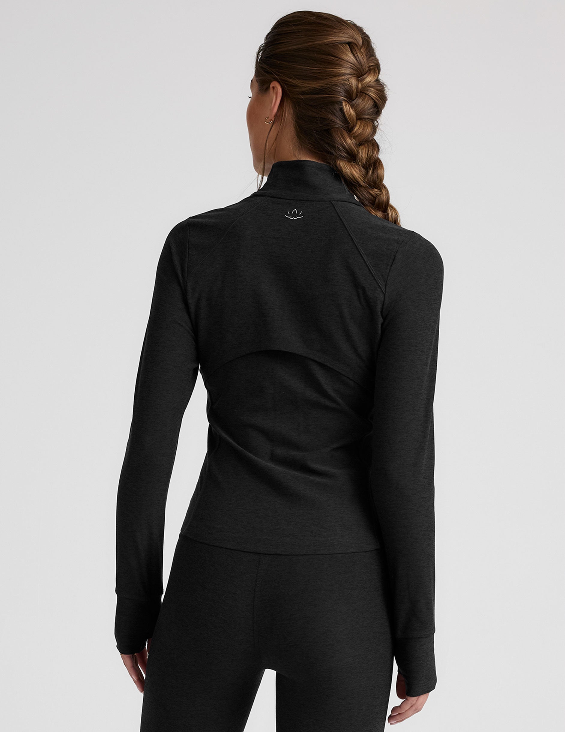 black zip-up mock neck jacket with pockets and thumbholes.