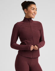 red zip-up mock neck jacket with pockets and thumbholes.