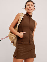 brown zip-up vest with a mesh upper back detail and pockets.