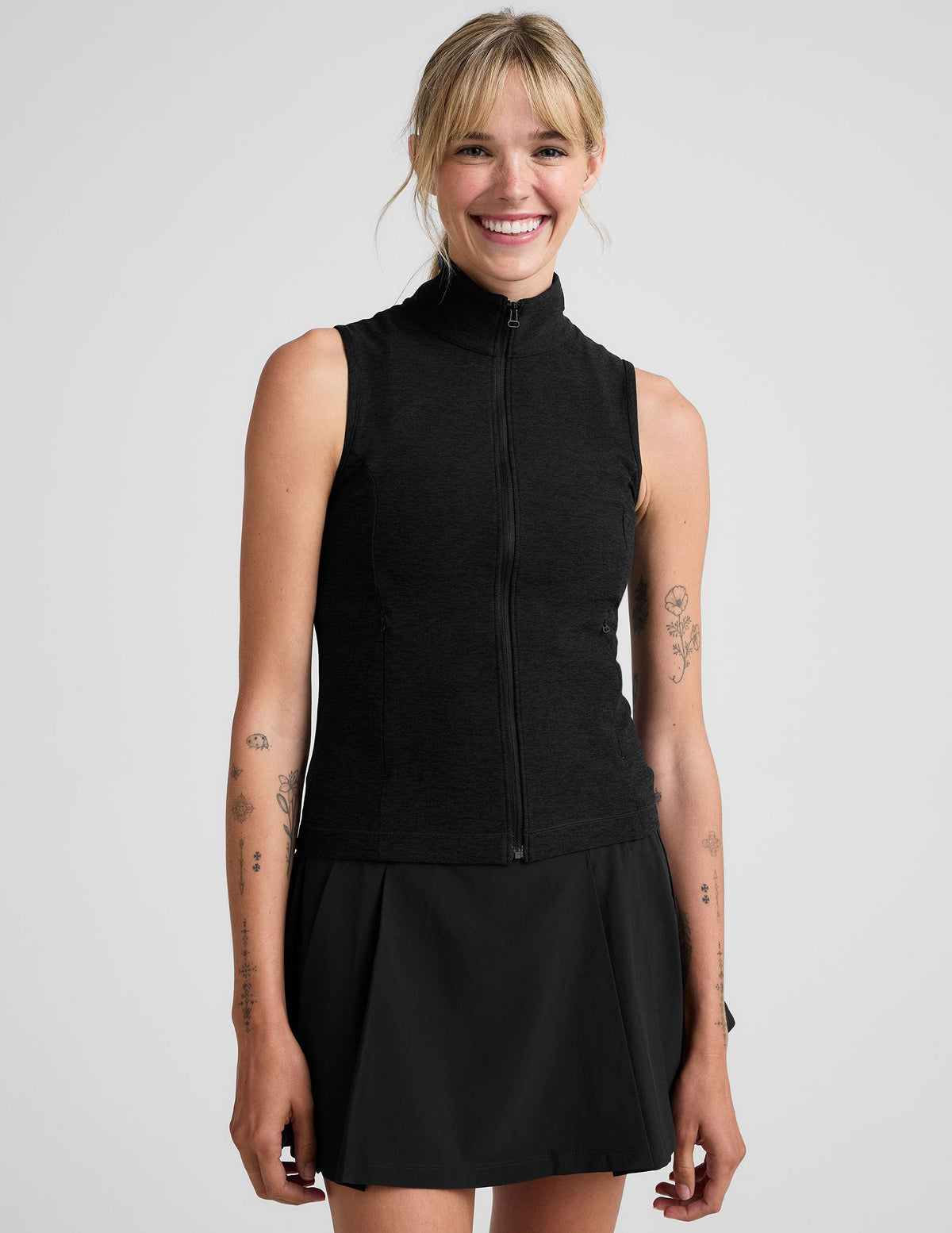 black zip-up vest with a mesh upper back detail.