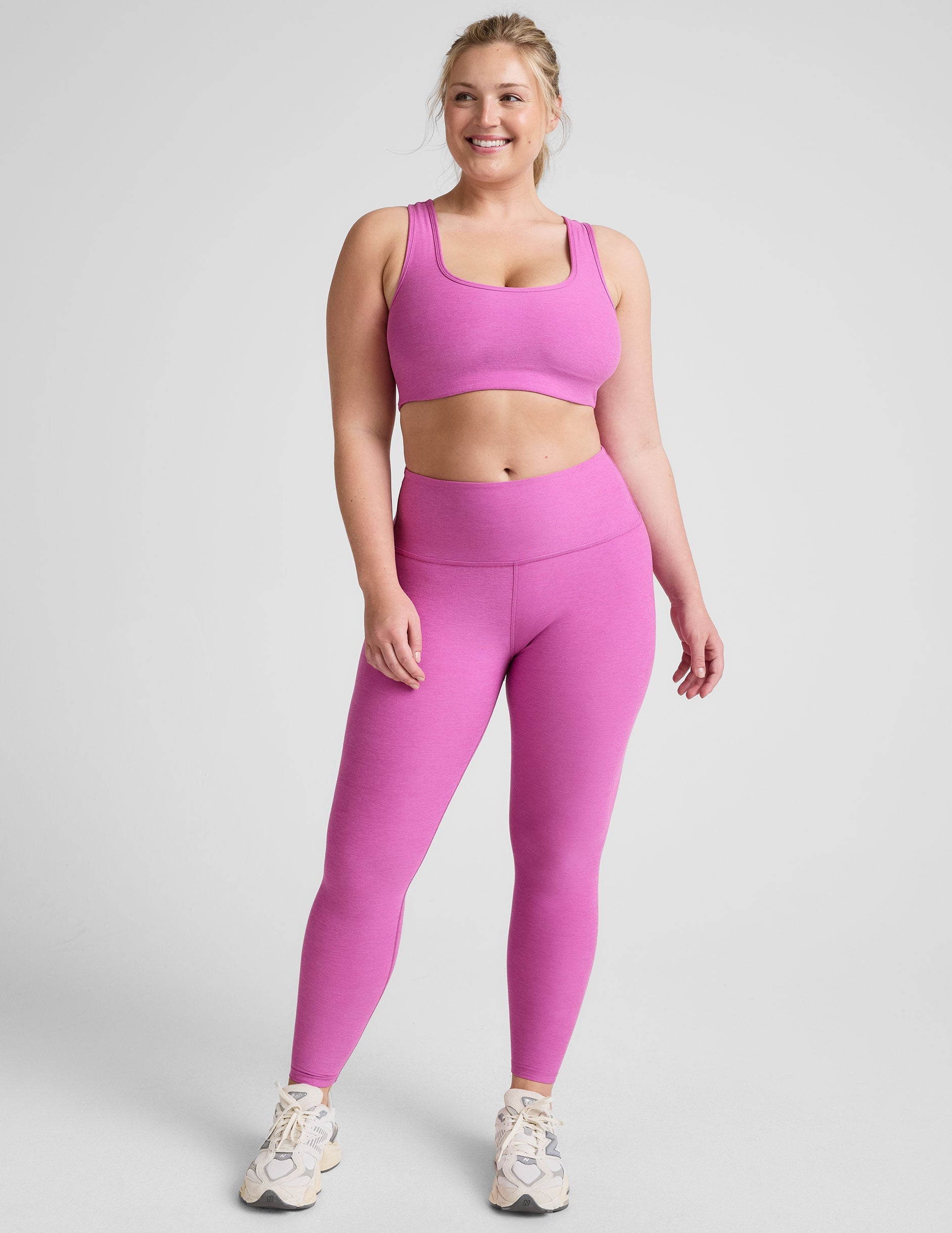 pink high-waisted midi length leggings.