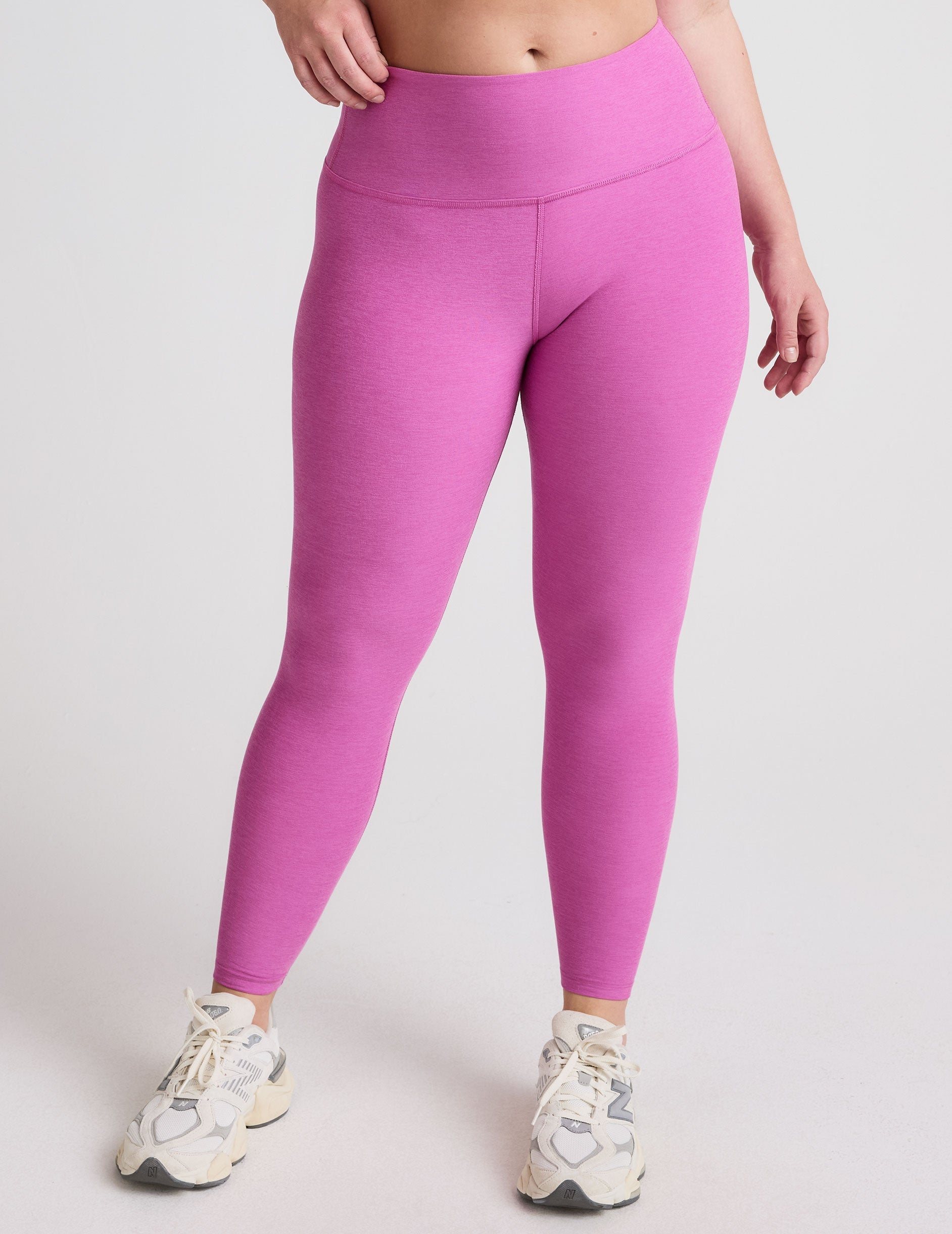 pink high-waisted midi length leggings.