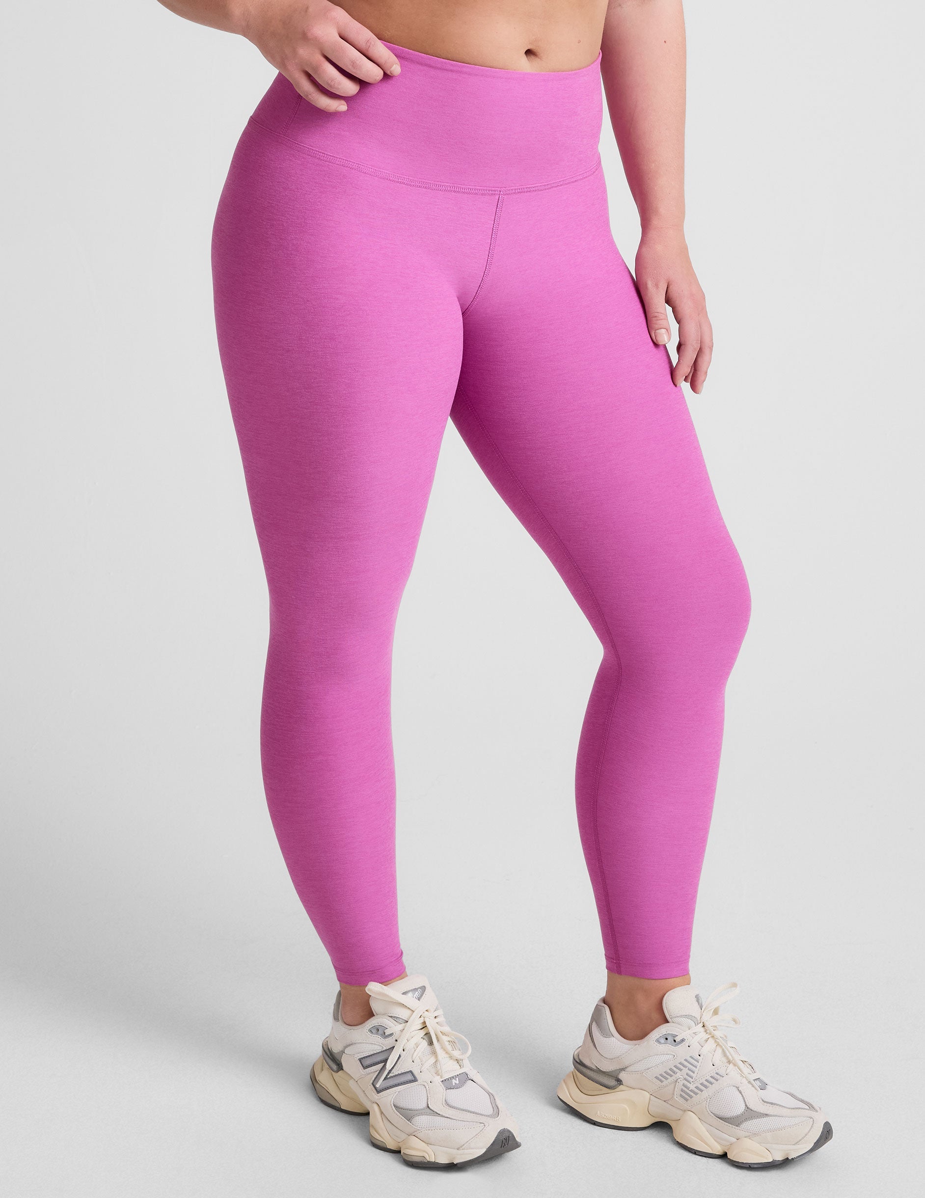 pink high-waisted midi length leggings.