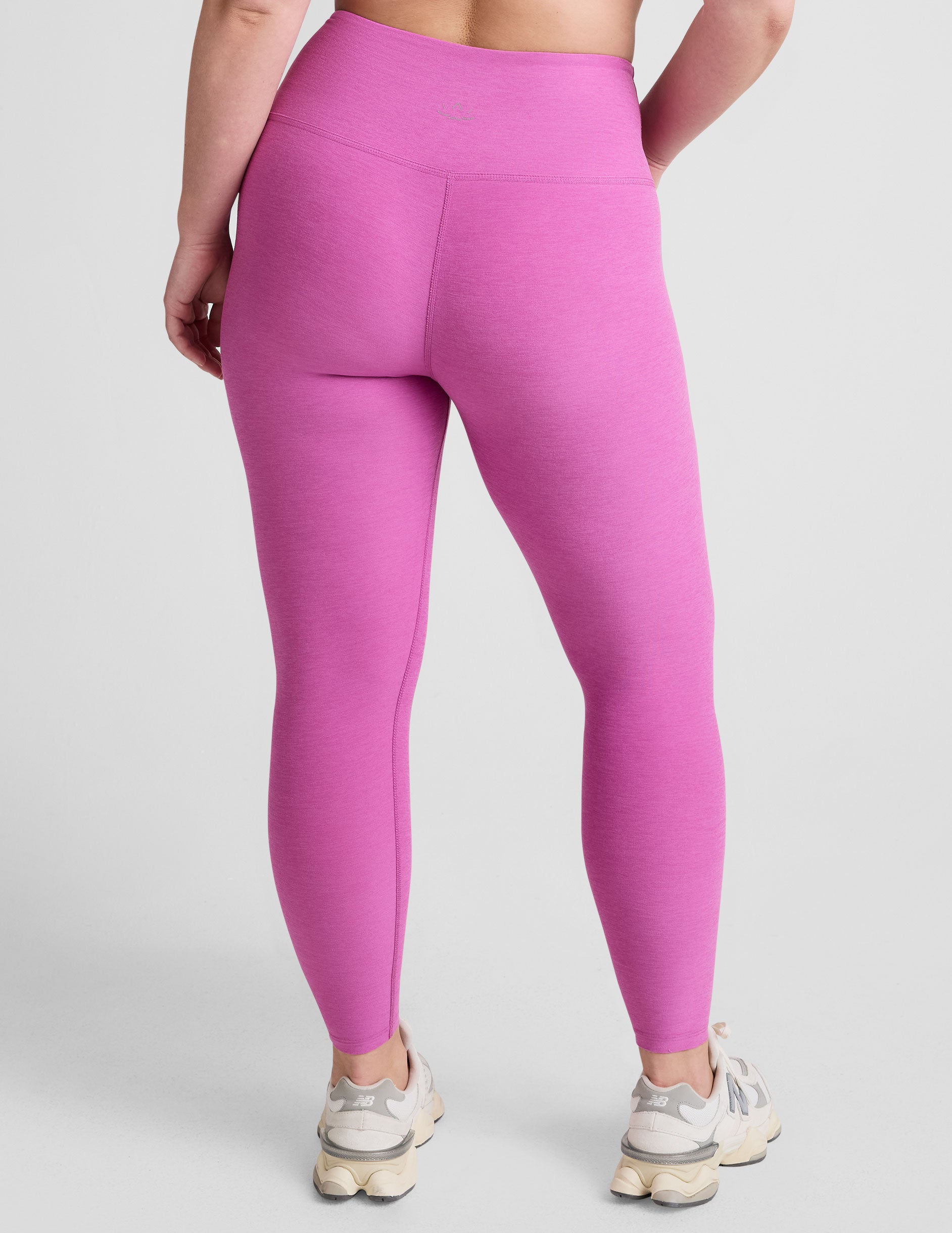 pink high-waisted midi length leggings.