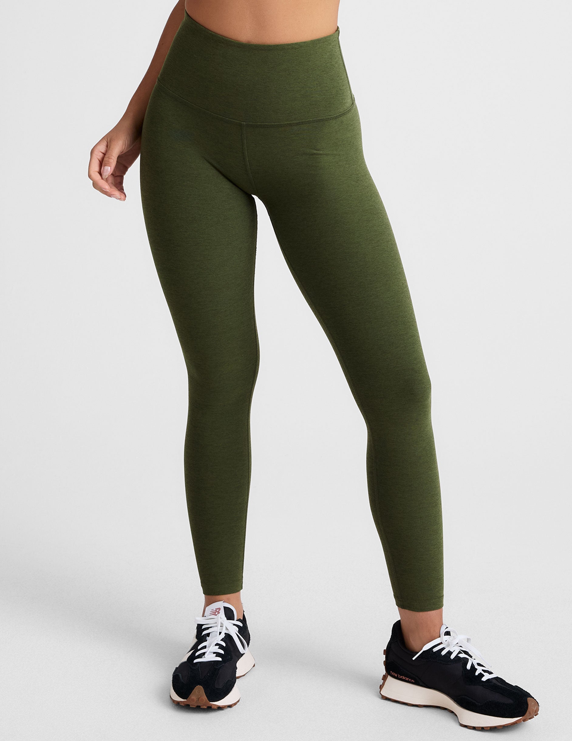 green high-waisted midi length leggings.