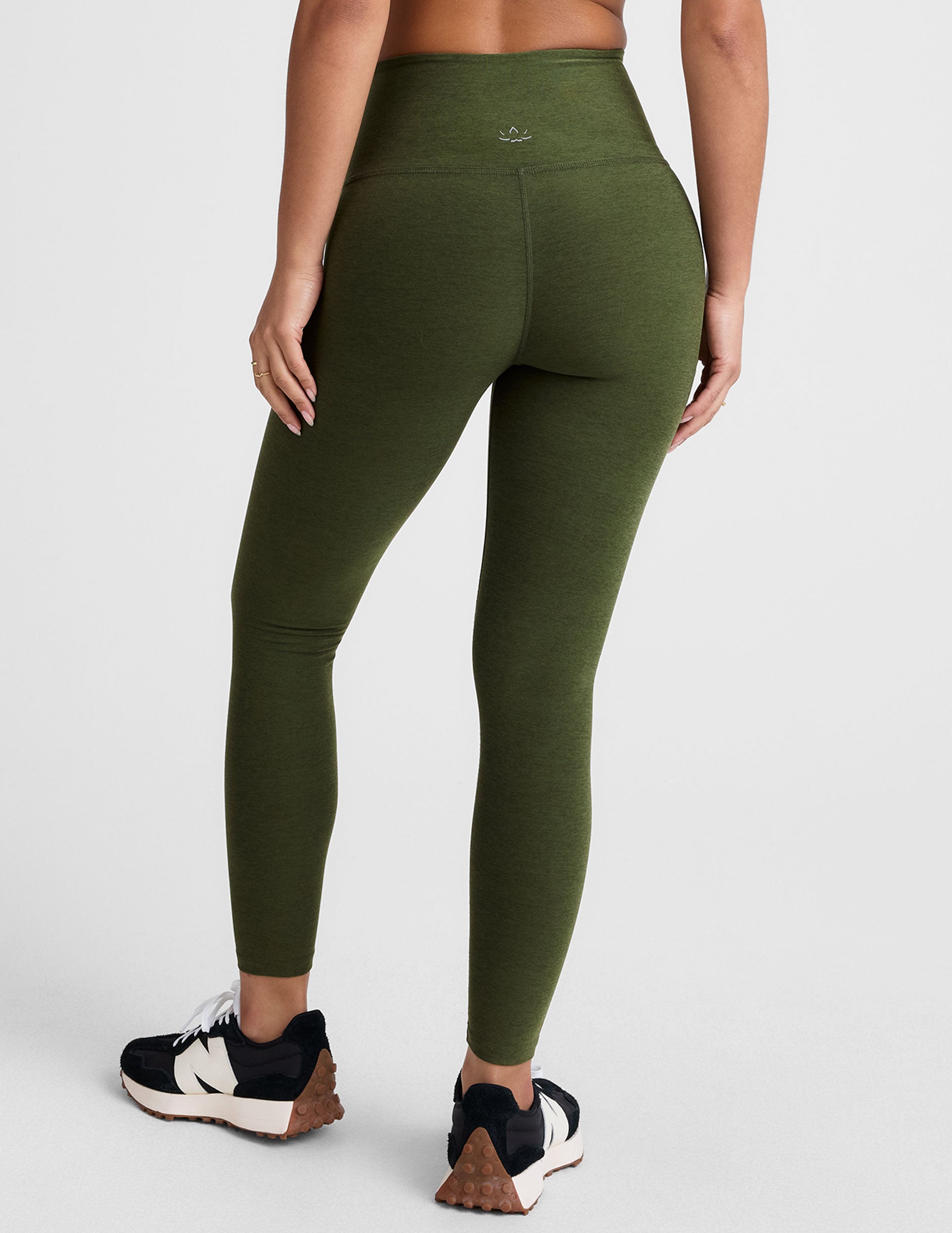 green high-waisted midi length leggings.