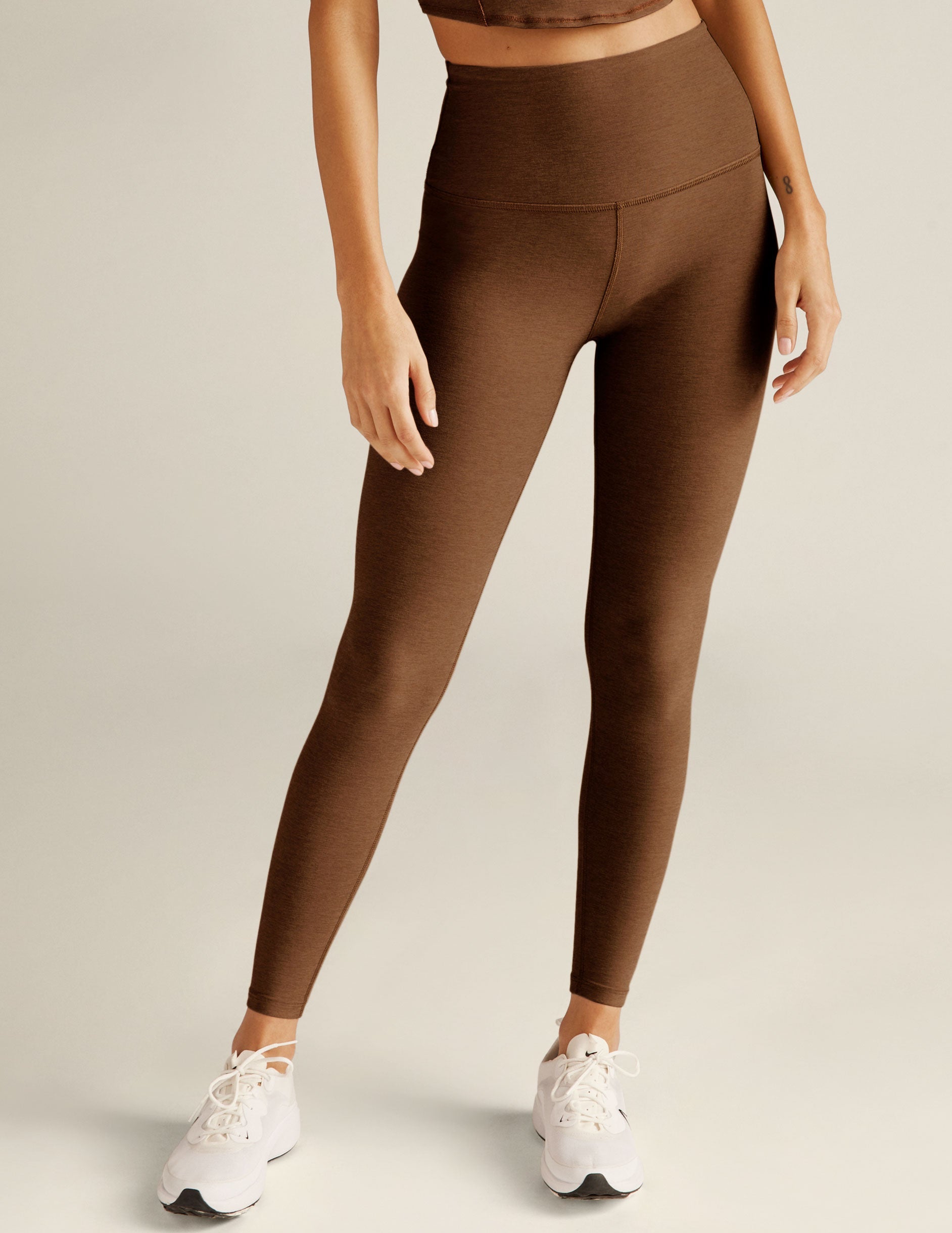 brown high-waisted midi length leggings.