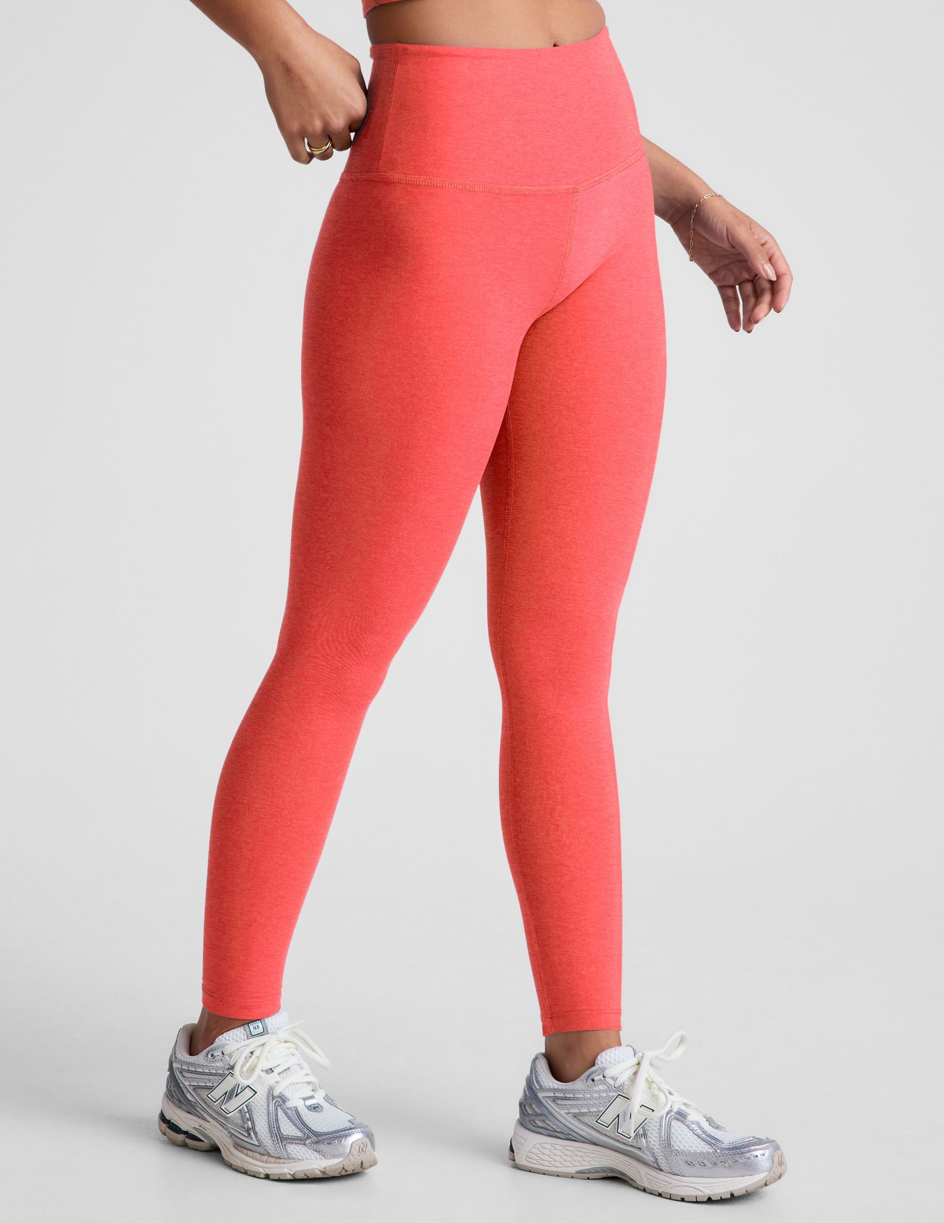 pink high-waisted midi length leggings.