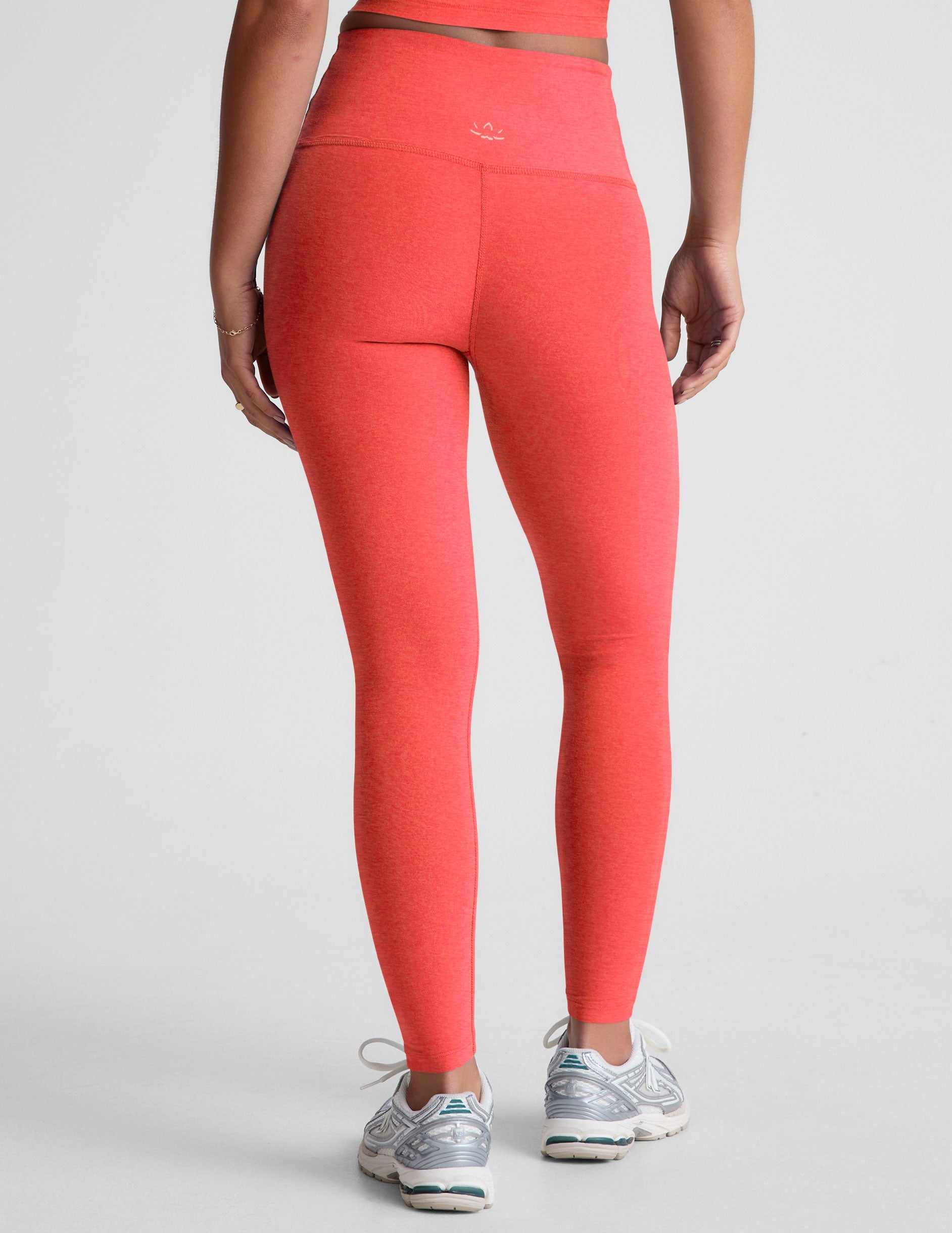 pink high-waisted midi length leggings.