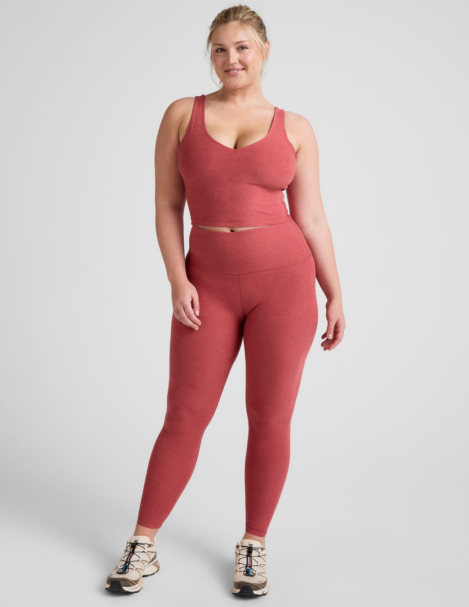 red high-waisted midi length leggings.
