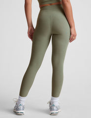 green high-waisted midi length leggings.
