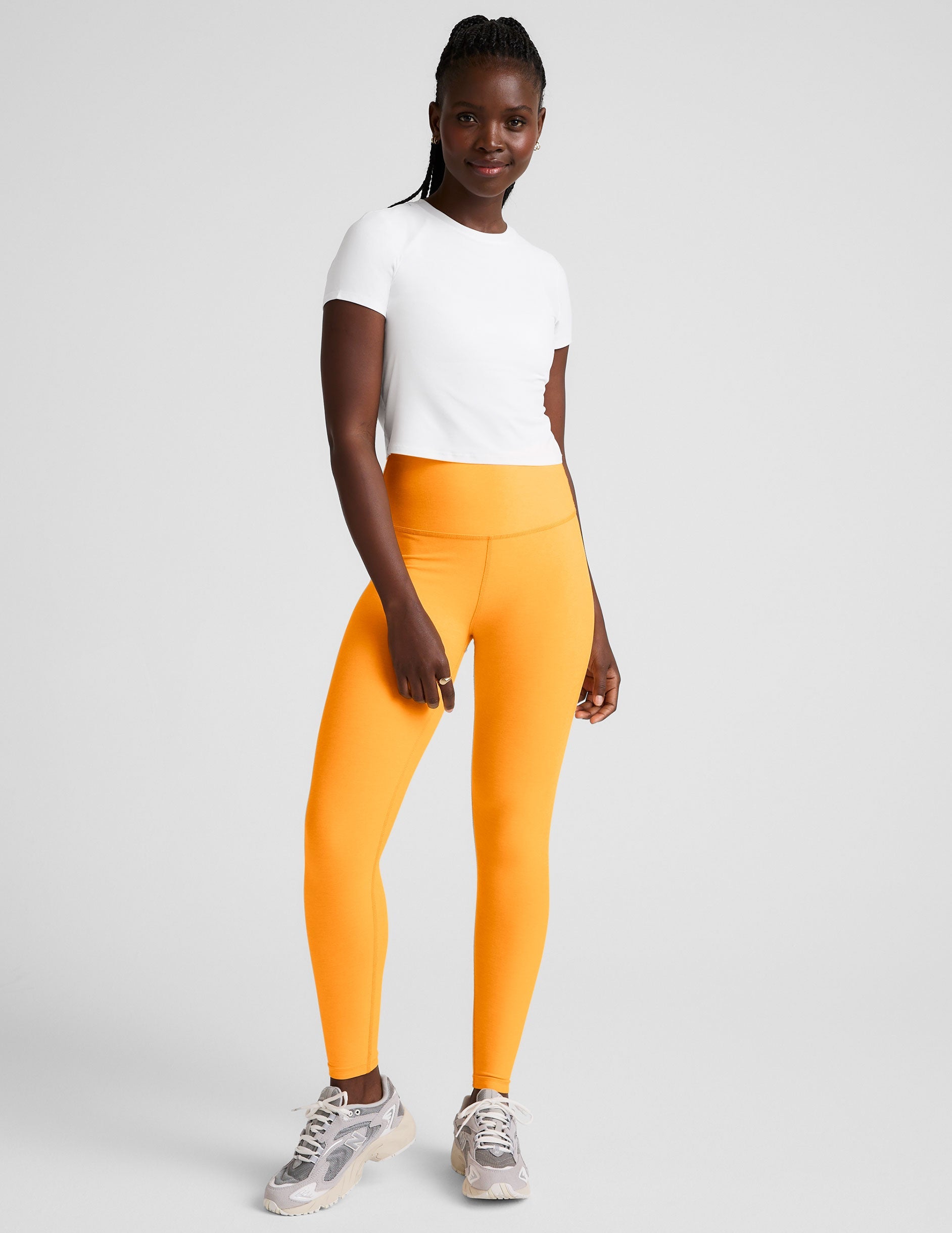 orange high-waisted midi length leggings.