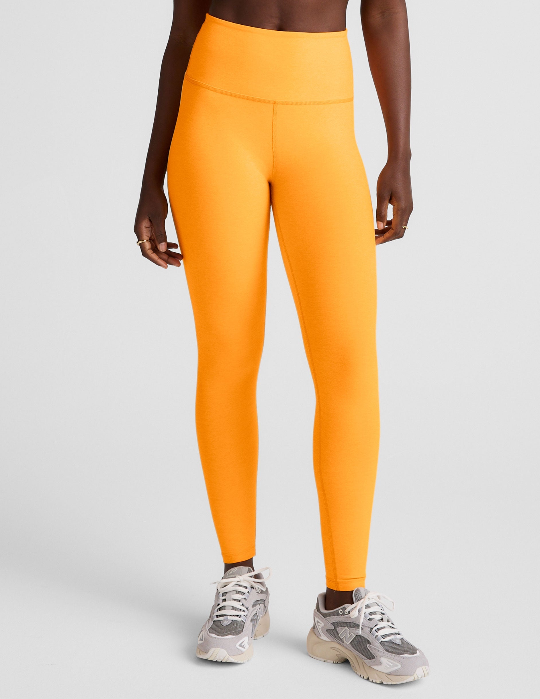 orange high-waisted midi length leggings.