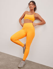 orange high-waisted midi length leggings.