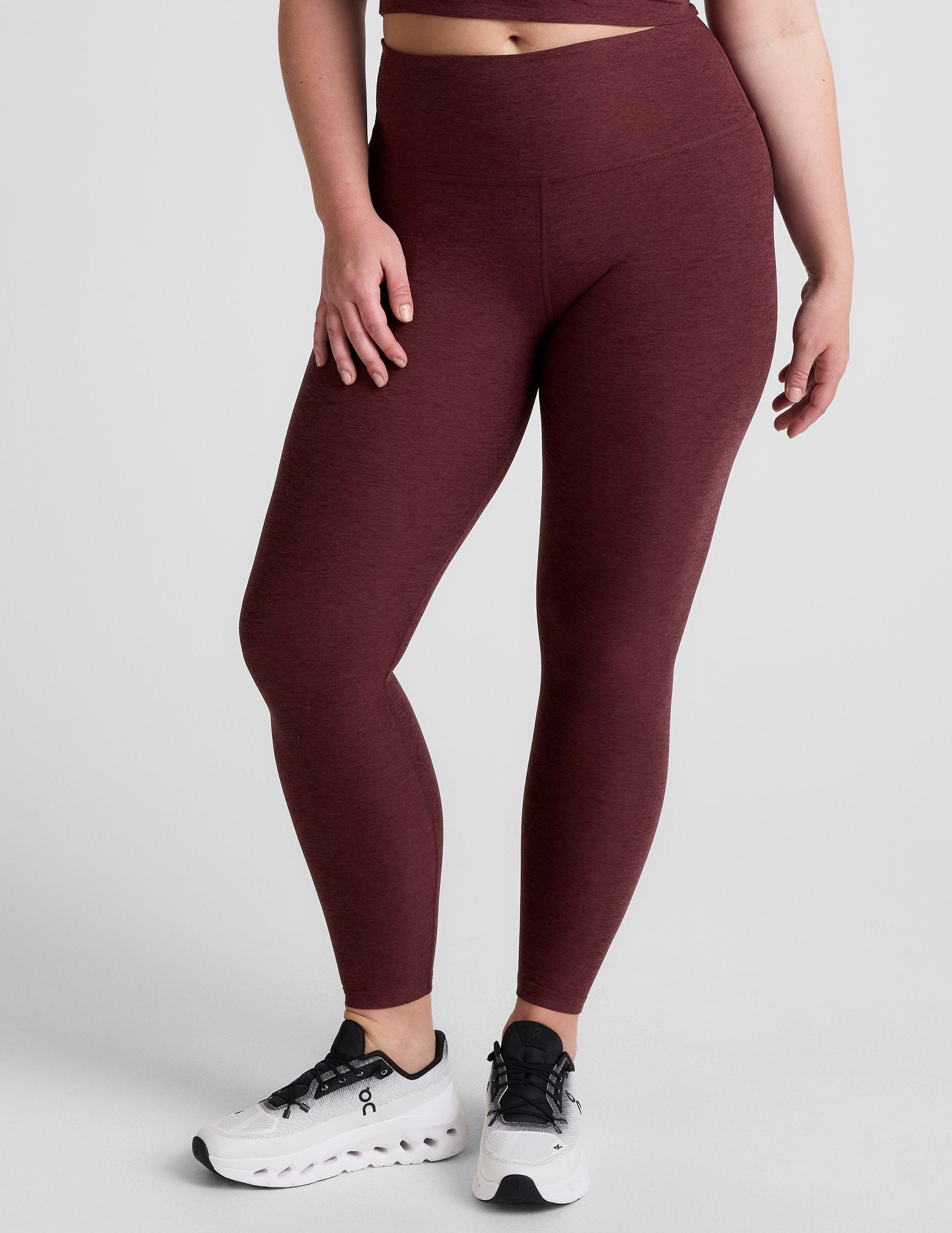 red high-waisted midi length leggings.