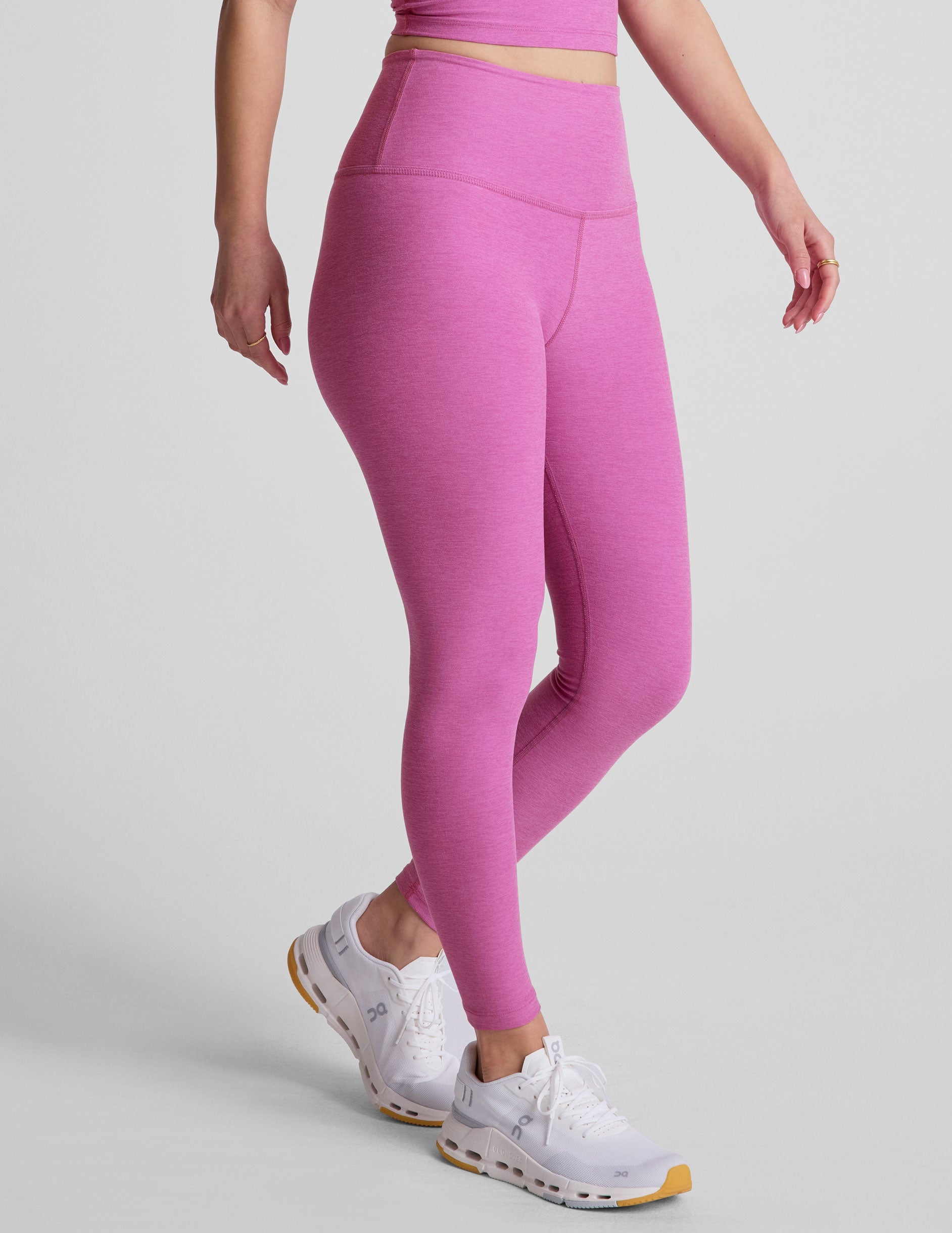 pink high-waisted midi length leggings.
