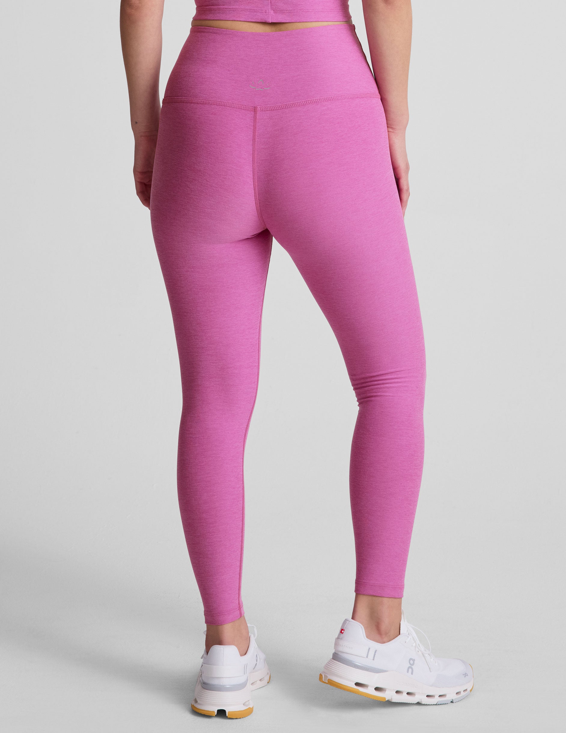 pink high-waisted midi length leggings.