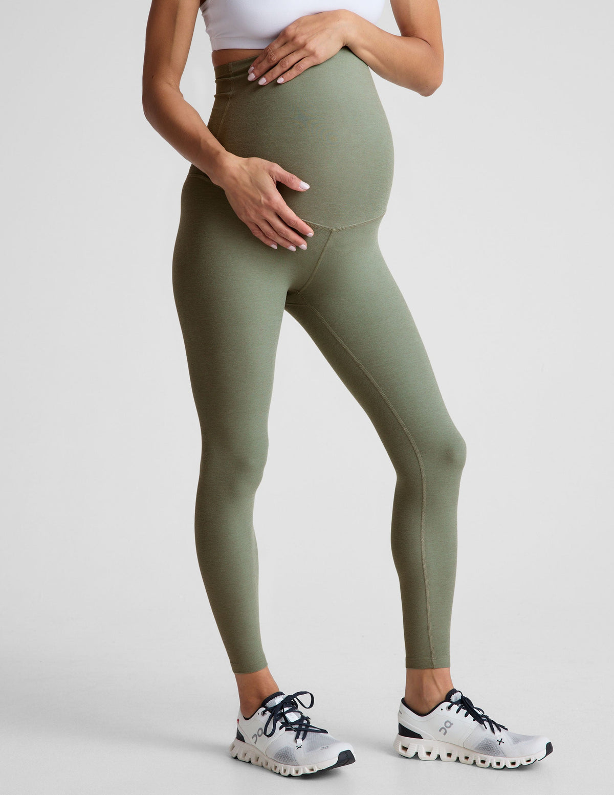 green high-waisted midi length maternity leggings.