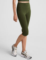 model is wearing green high-waisted pedal pusher length leggings.