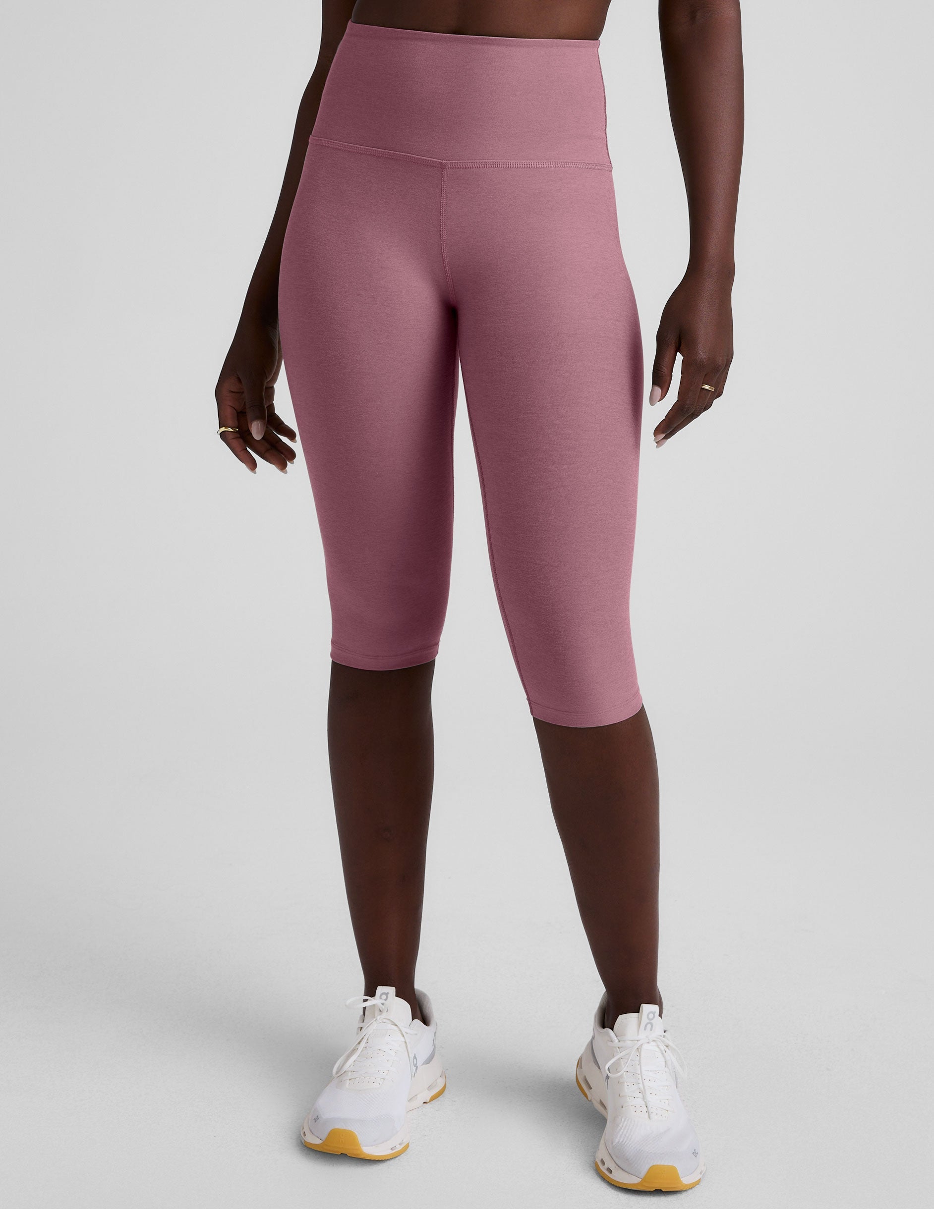 pink high-waisted pedal pusher length leggings.