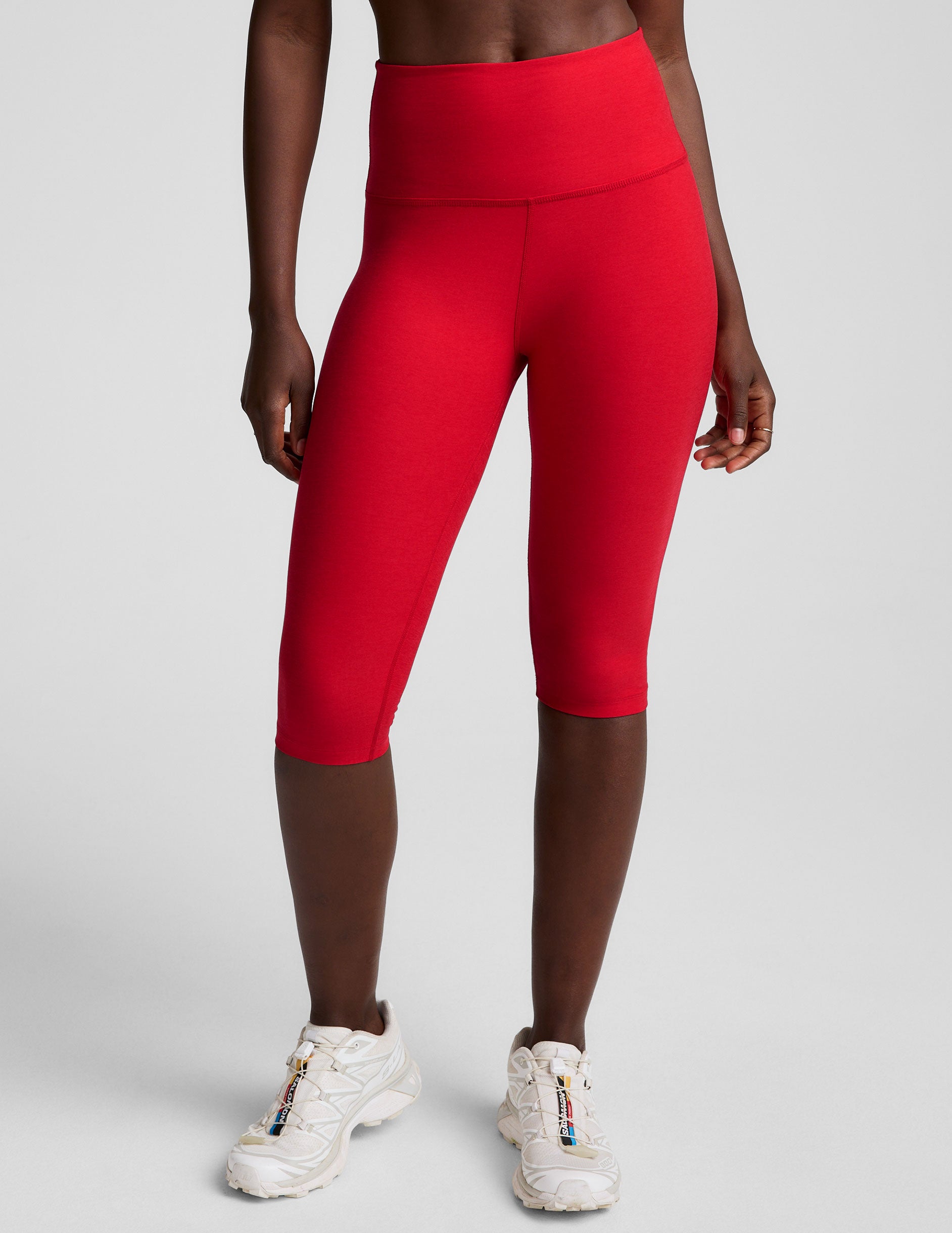 red high-waisted pedal pusher length leggings.