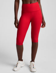 red high-waisted pedal pusher length leggings.