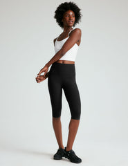 black high-waisted pedal pusher length leggings.