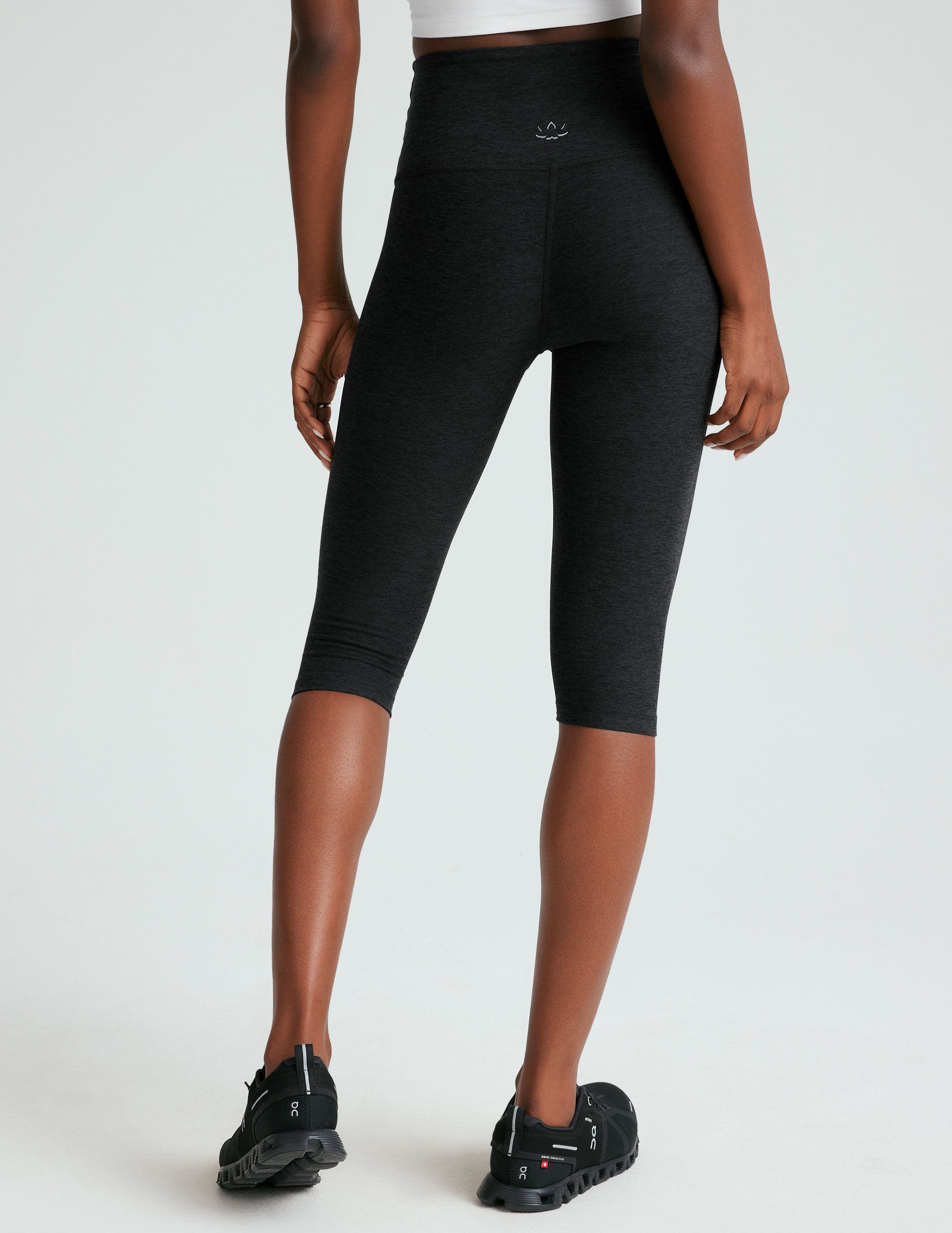 black high-waisted pedal pusher length leggings.