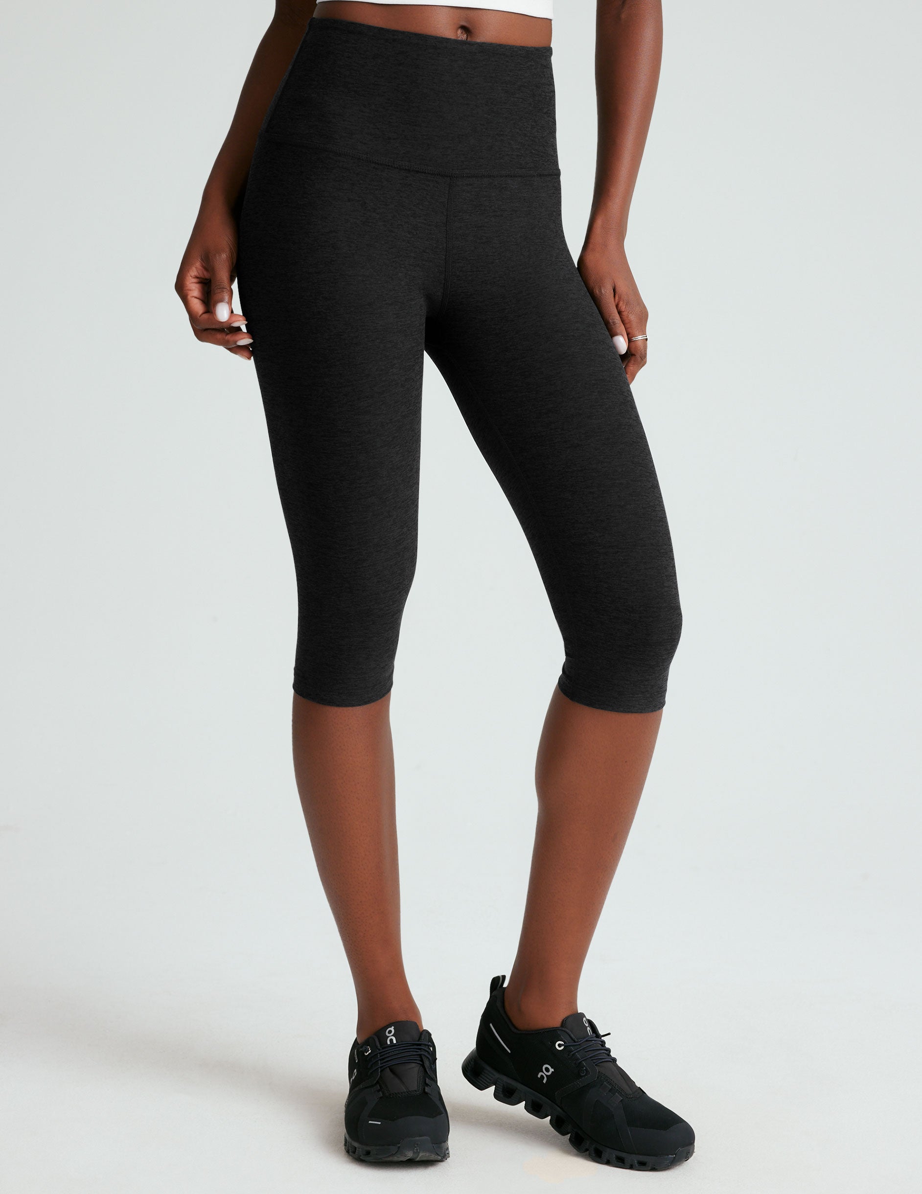 black high-waisted pedal pusher length leggings.