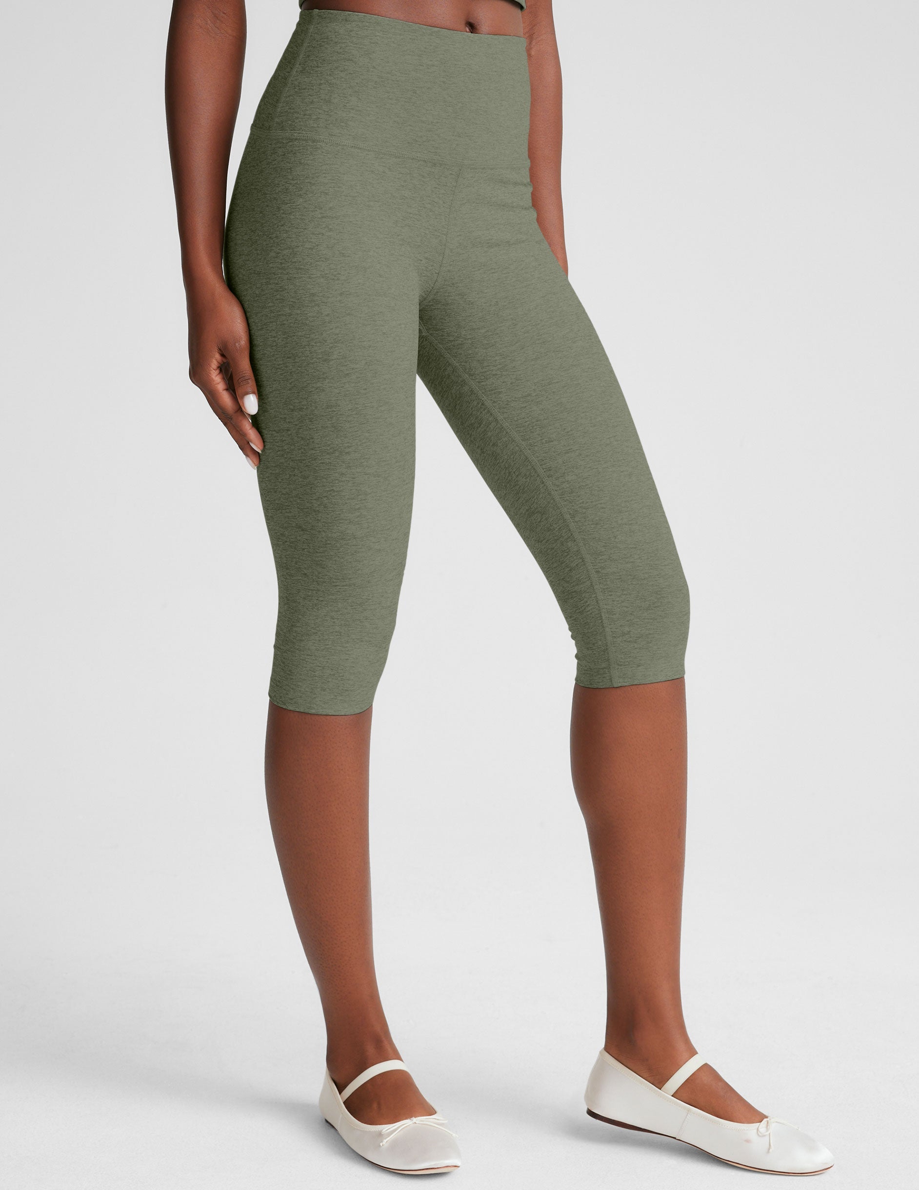 green high-waisted pedal pusher length leggings.