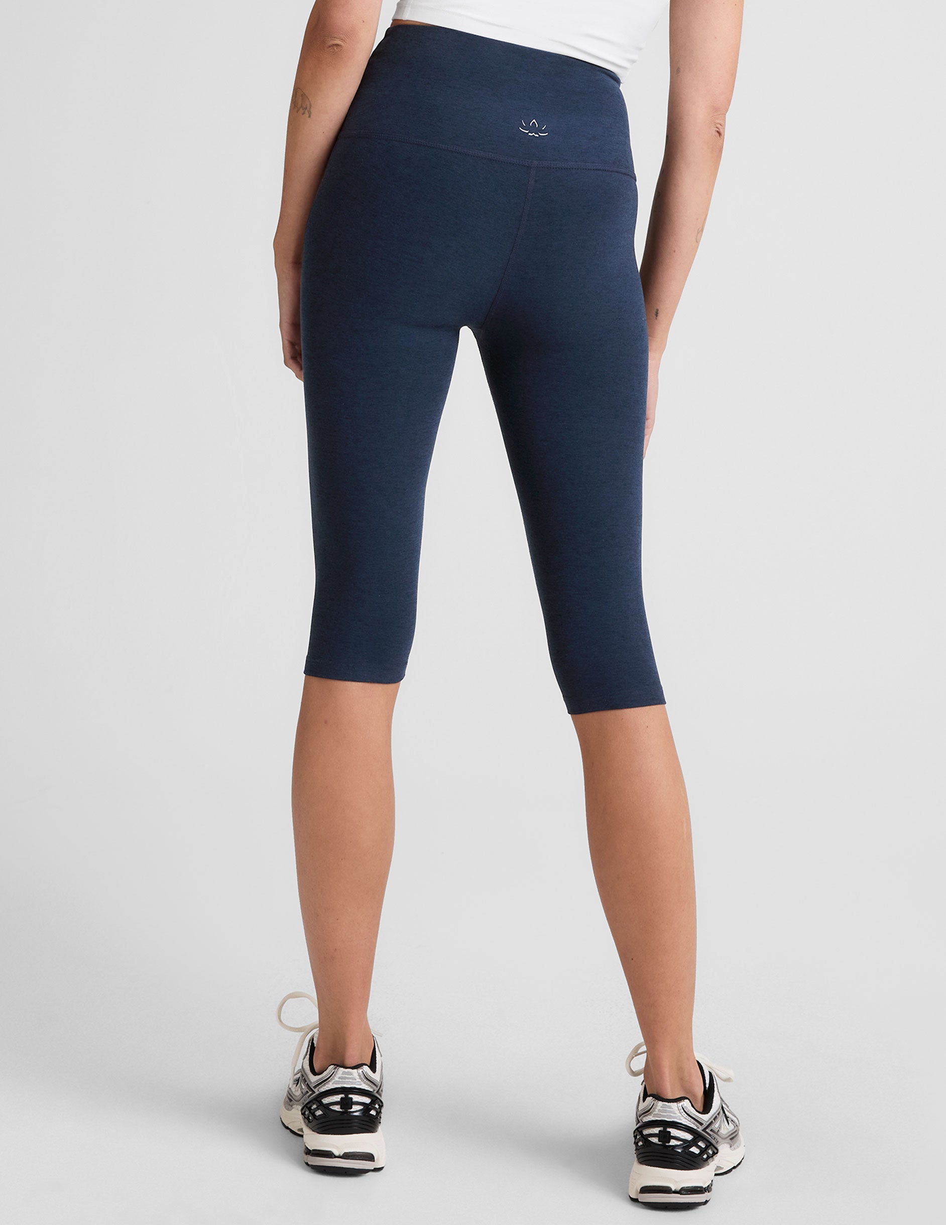 blue high-waisted pedal pusher length leggings.