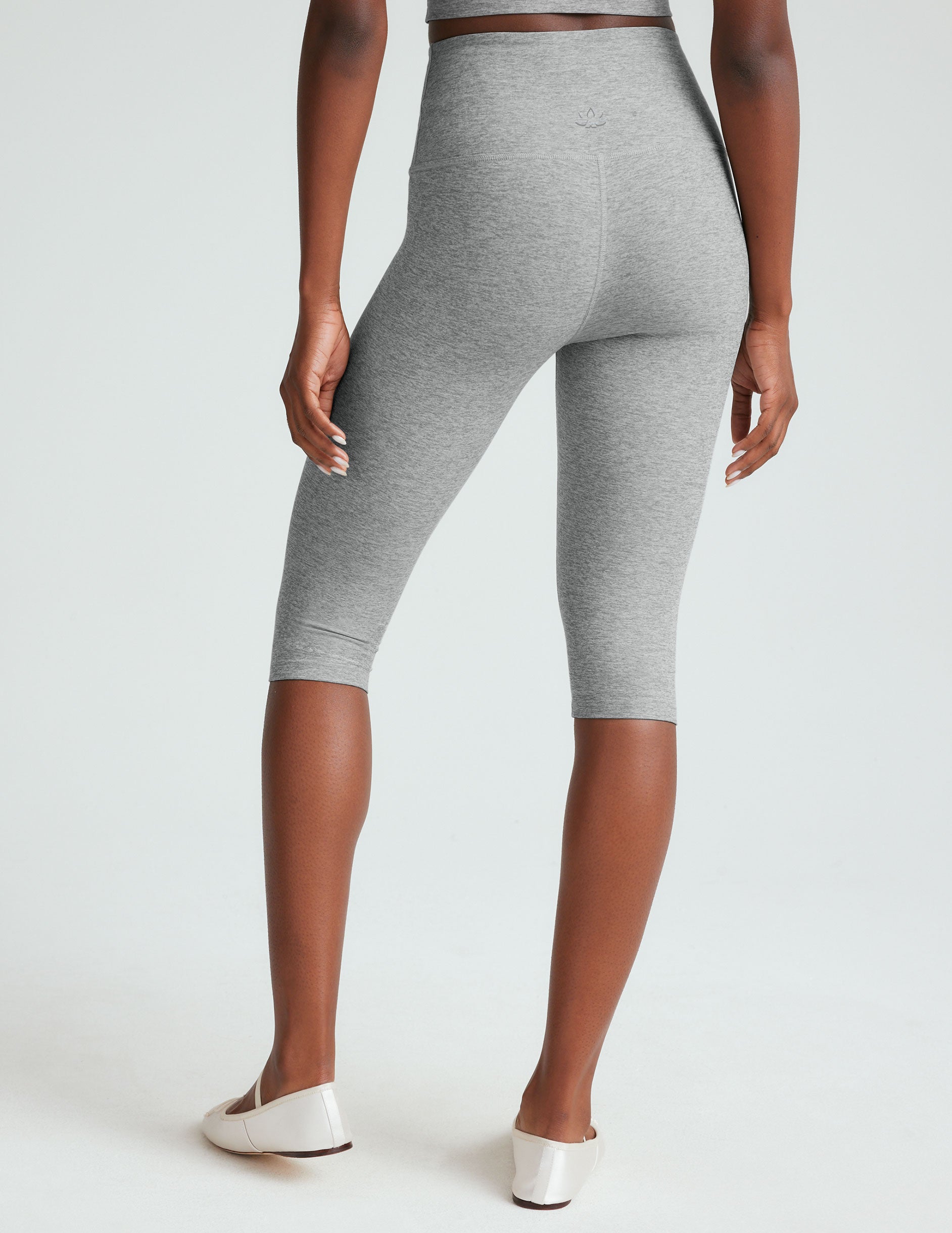 gray high-waisted pedal pusher length leggings.