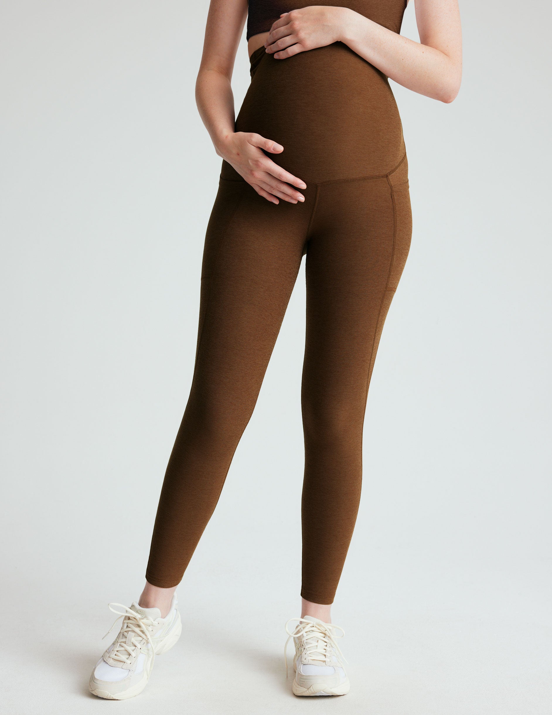 brown high-waisted maternity leggings with pockets.