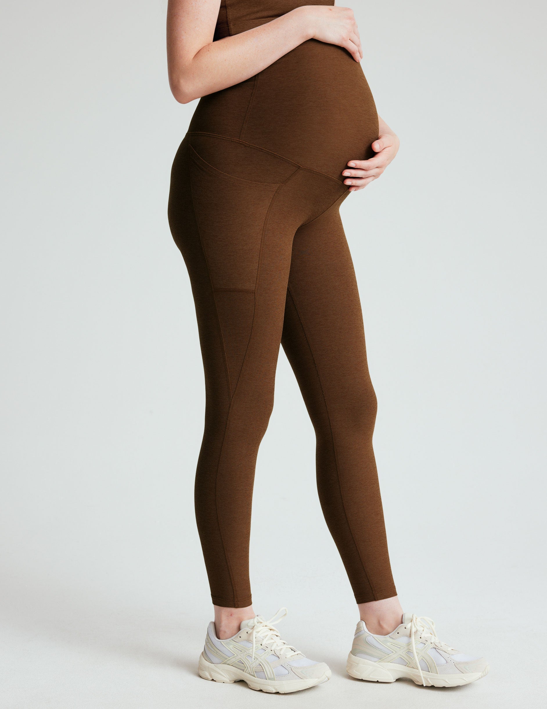 brown high-waisted maternity leggings with pockets.