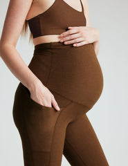 brown high-waisted maternity leggings with pockets.