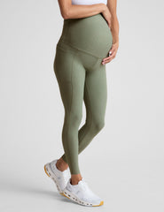 green high-waisted maternity leggings with pockets.