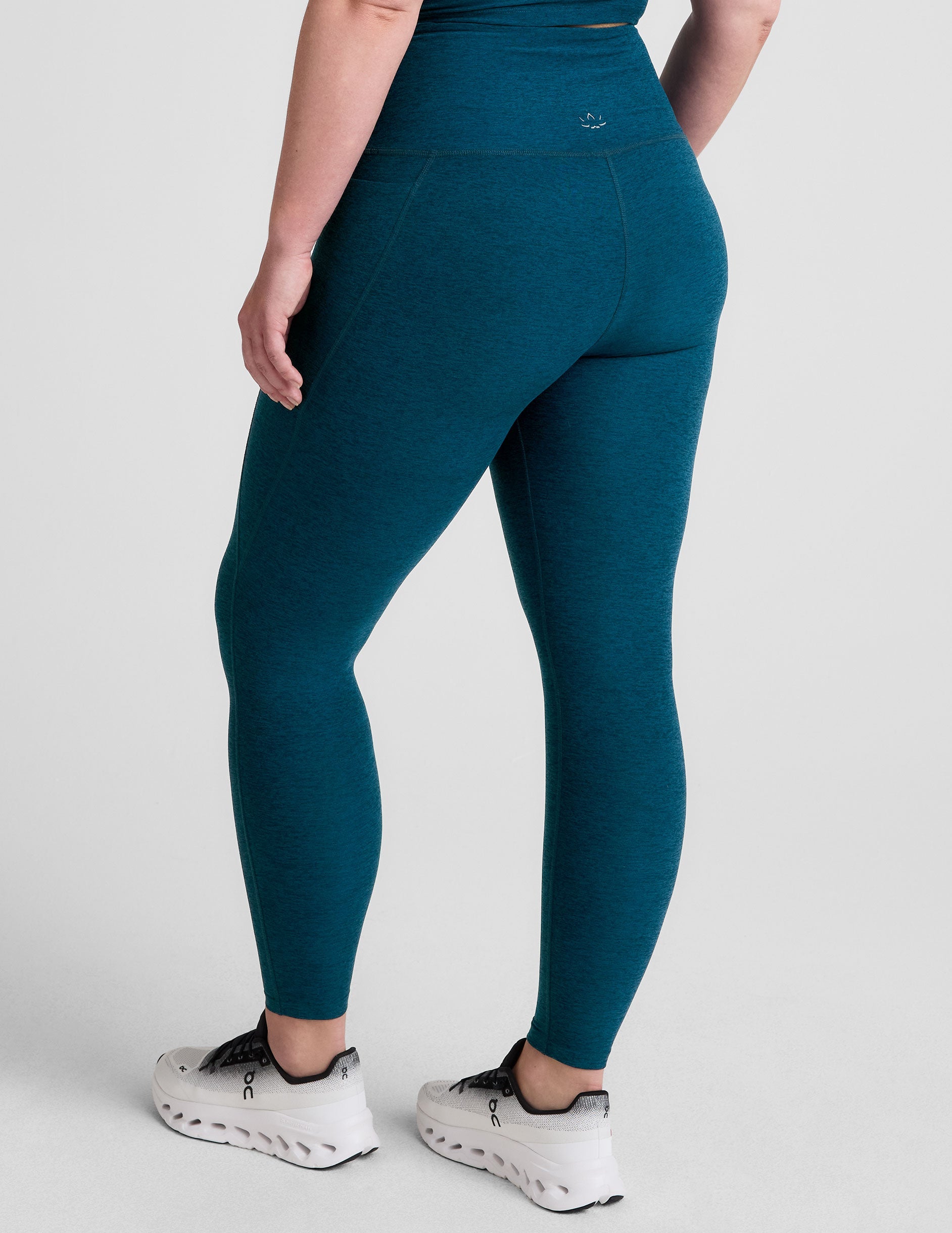 blue high-waisted midi length leggings with side pockets.