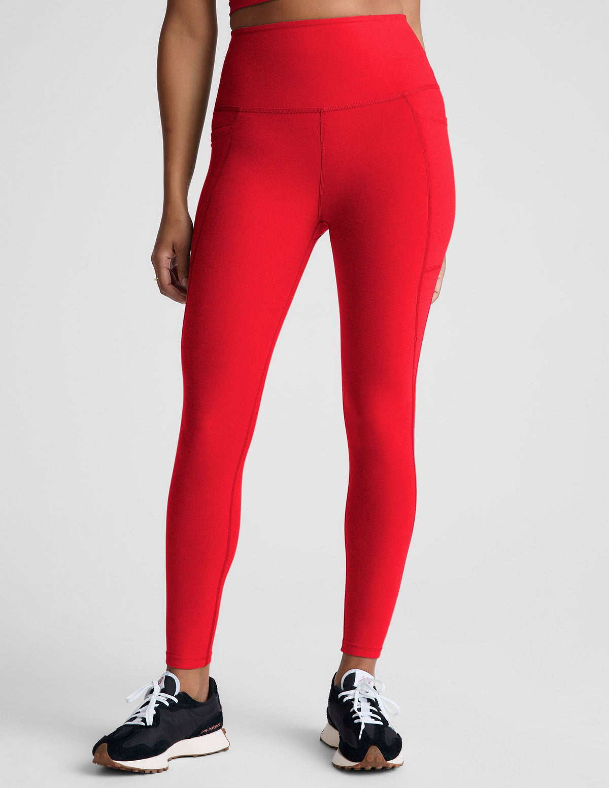 red high-waisted midi leggings with side pockets.