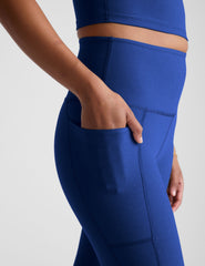 blue high-waisted midi length leggings with side pockets.