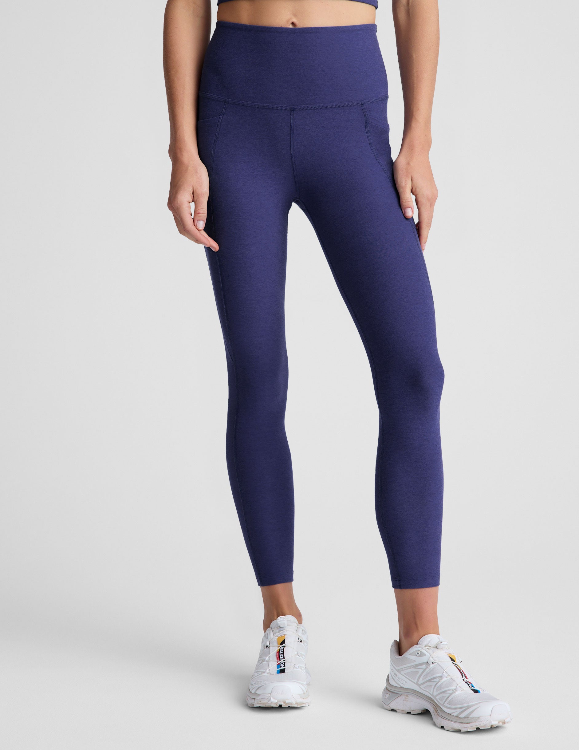 blue midi length high-waisted leggings with side pockets.