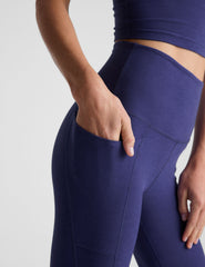 blue midi length high-waisted leggings with side pockets.