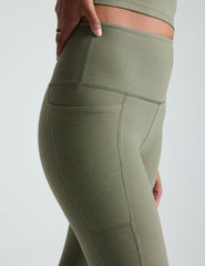 green high-waisted midi length legging with side pockets.